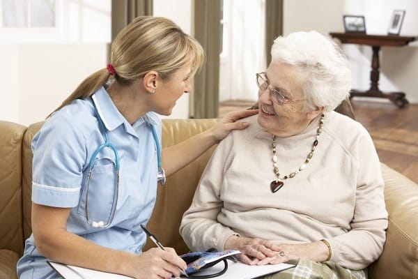 Senior Woman In Discussion With Health Visitor At Home Senior Woman In Discussion With Health Visitor At Home